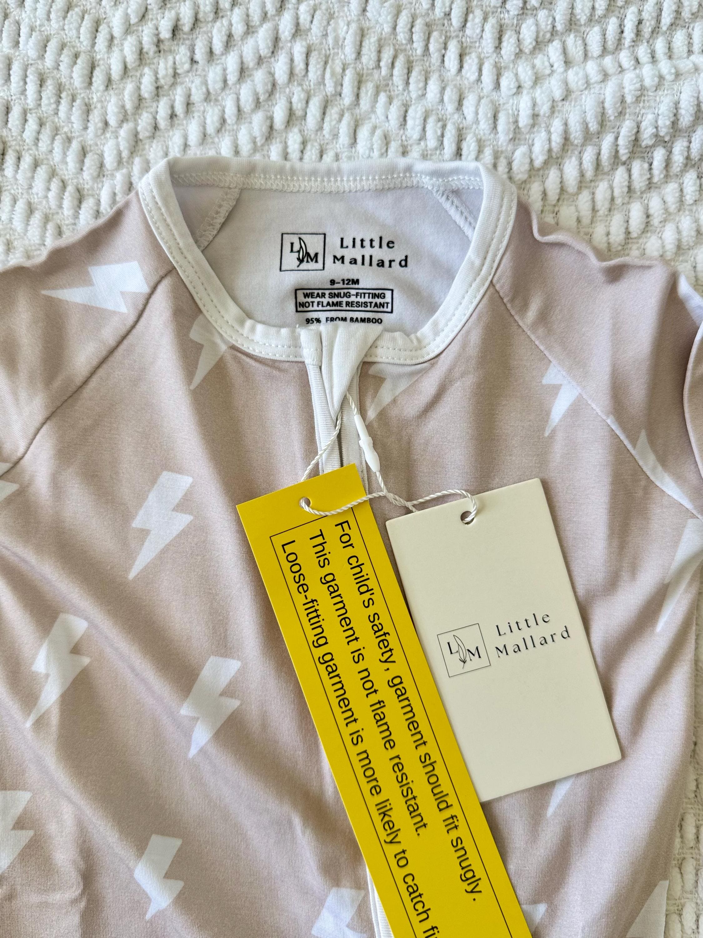 Breathable and soft Baby zipper sleeper with beige background and white lightning bolts made by Little Mallard