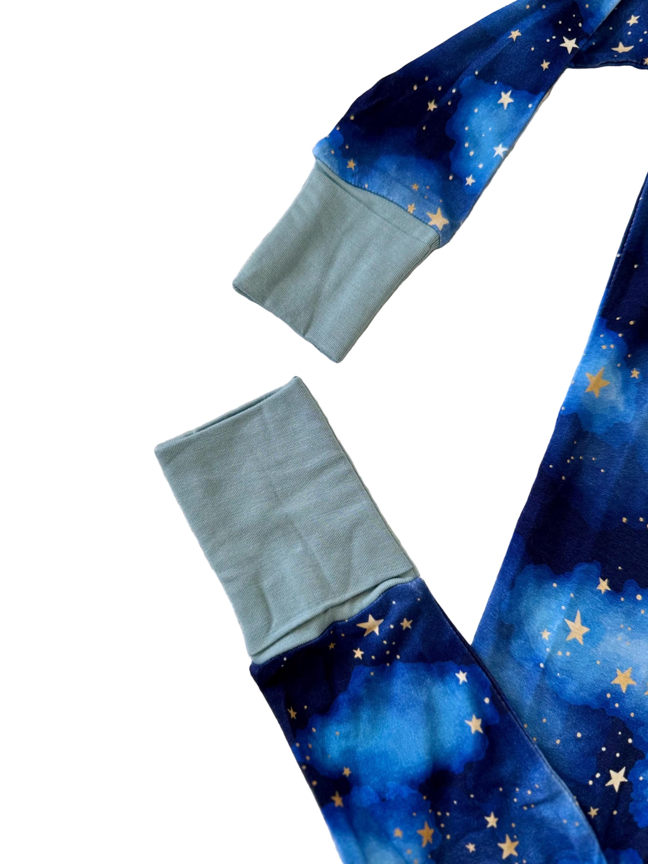 Soft baby convertible pajama/ onesie with galaxy pattern on a white background designed by Little Mallard. Fold over foot and mittens for baby pajama
