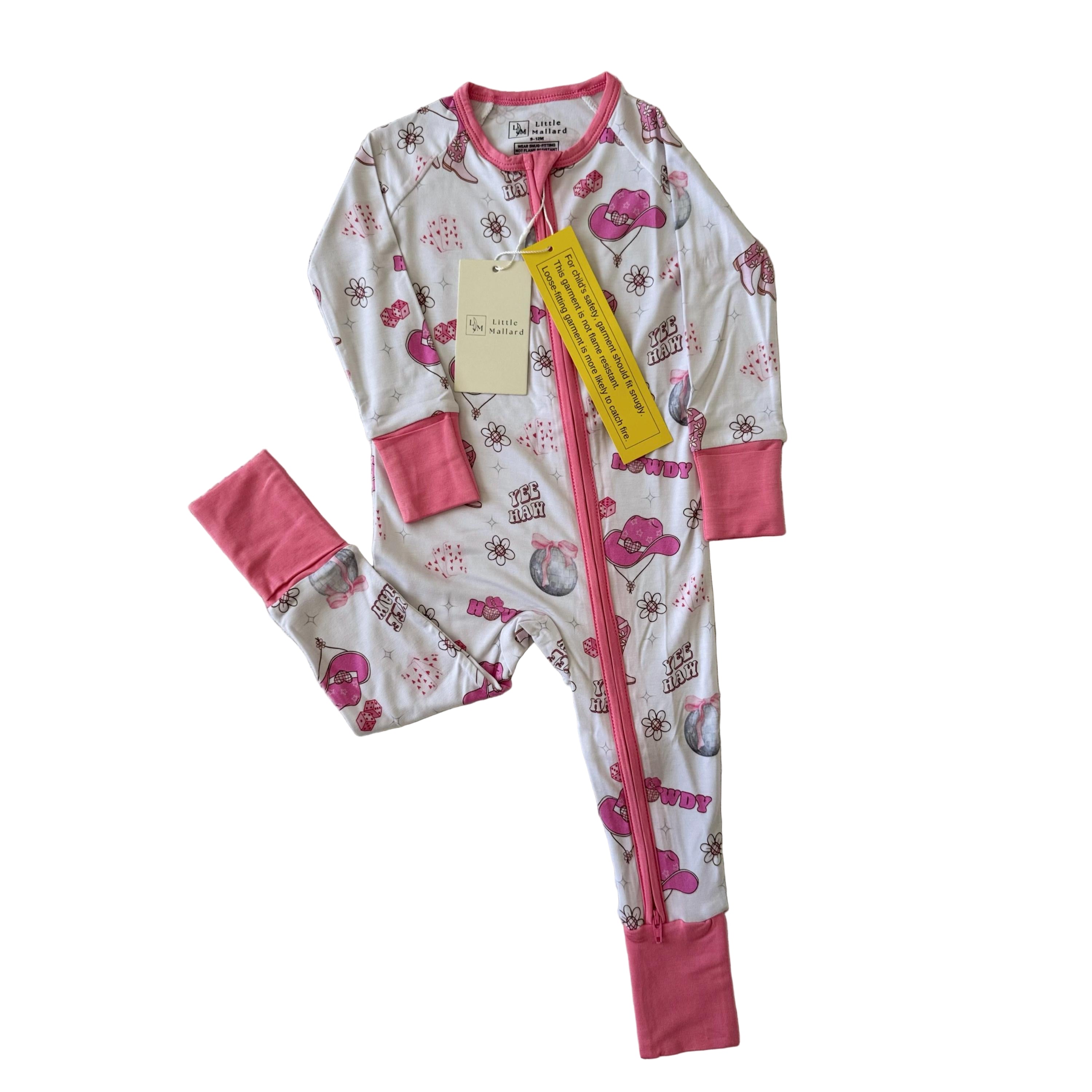 Baby onesie with pink cuffs with cowgirl hat, cowgirl oots, disco ball, howdy, flowers and cards. 
