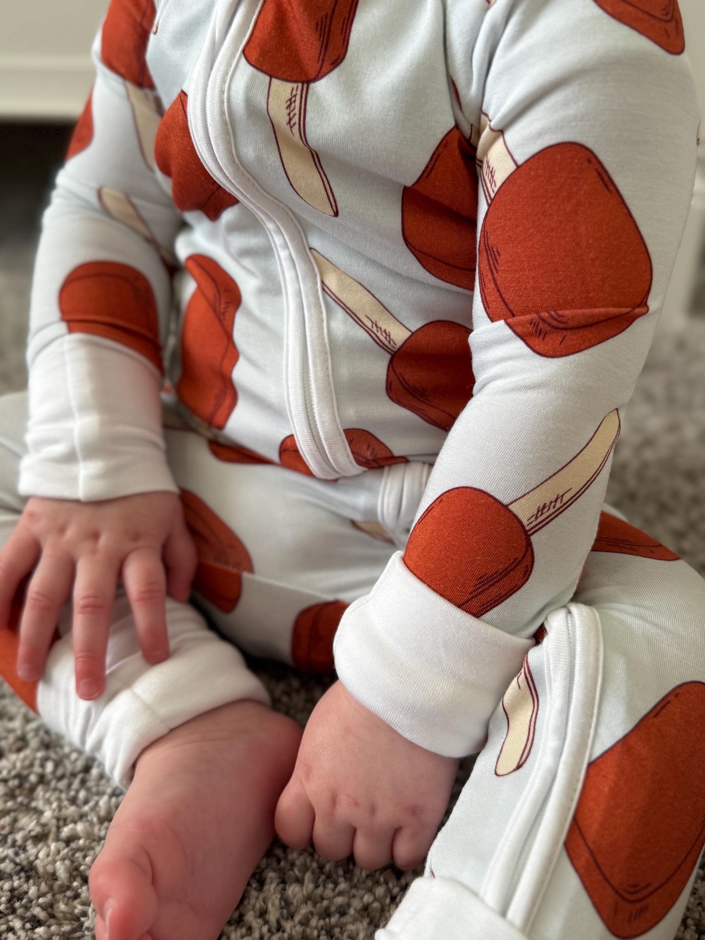 Baby wearing bamboo convertible pajama, footie pjs with light blue background and fudge bars for accent pieces. 
