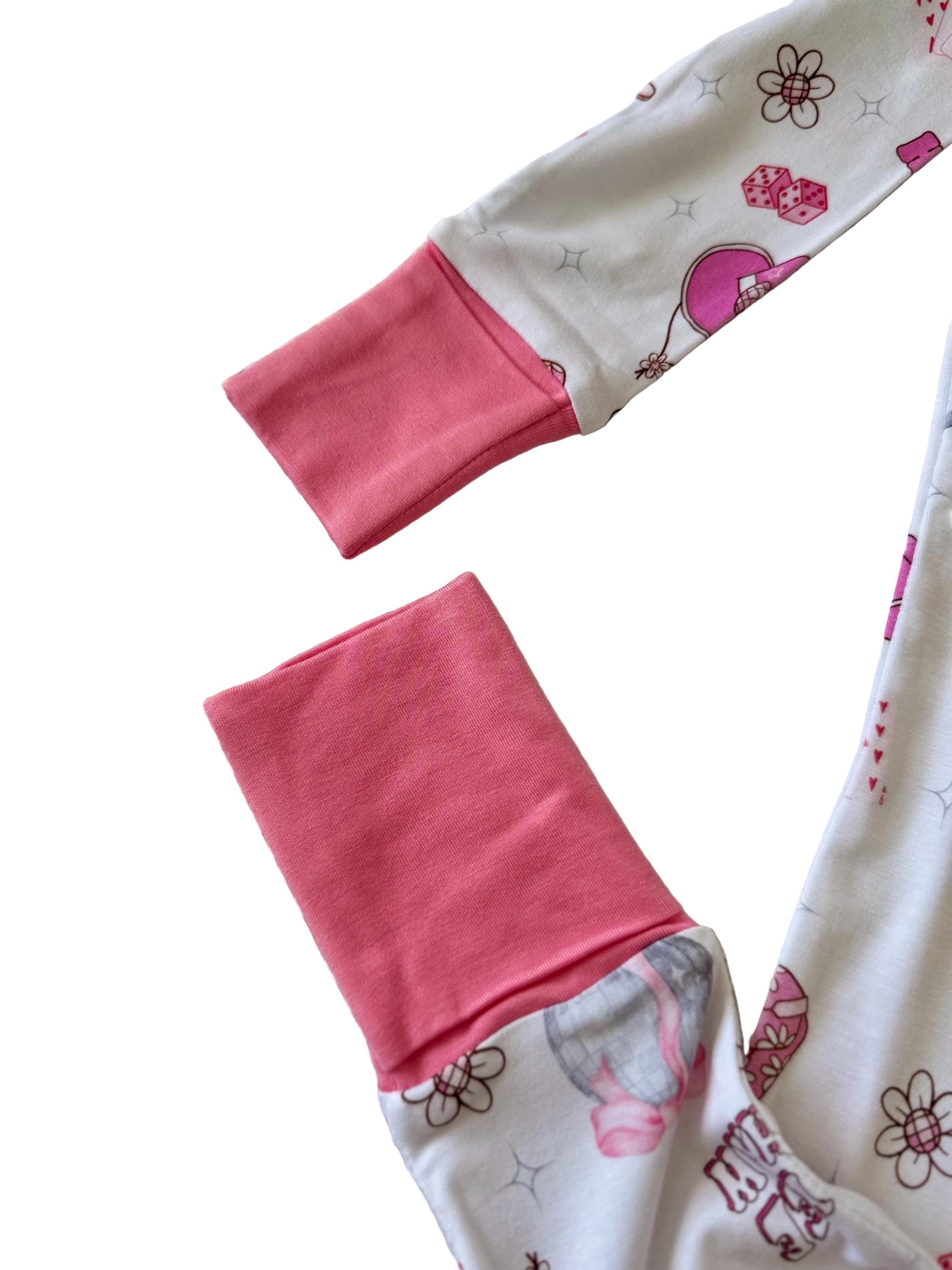 Bamboo convertible baby pajama with Pink and white baby pajamas with floral pattern, cowgirl pattern, western pattern, dice pattern, disco pattern, yeehaw pattern, Nashville pattern, Tennessee pattern, card pattern. 