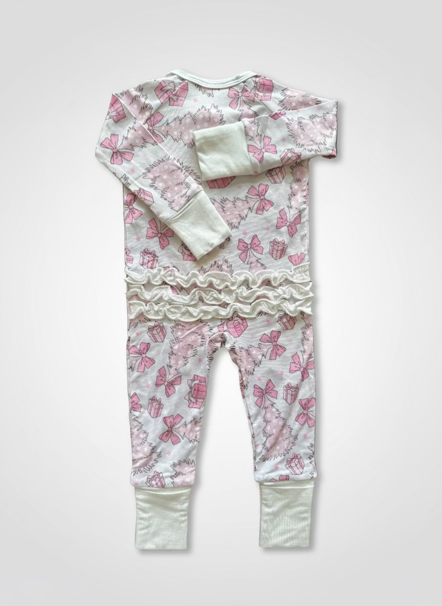 Baby Bamboo convertible footie pajama that is pale pink with pink and white christmas trees, bows, presents and stars. Pajamas are super soft, great for sensitive skin and will grow with your little - the mittens and feet are adjustable! Bottom includes ruffles, ruffle butt. 