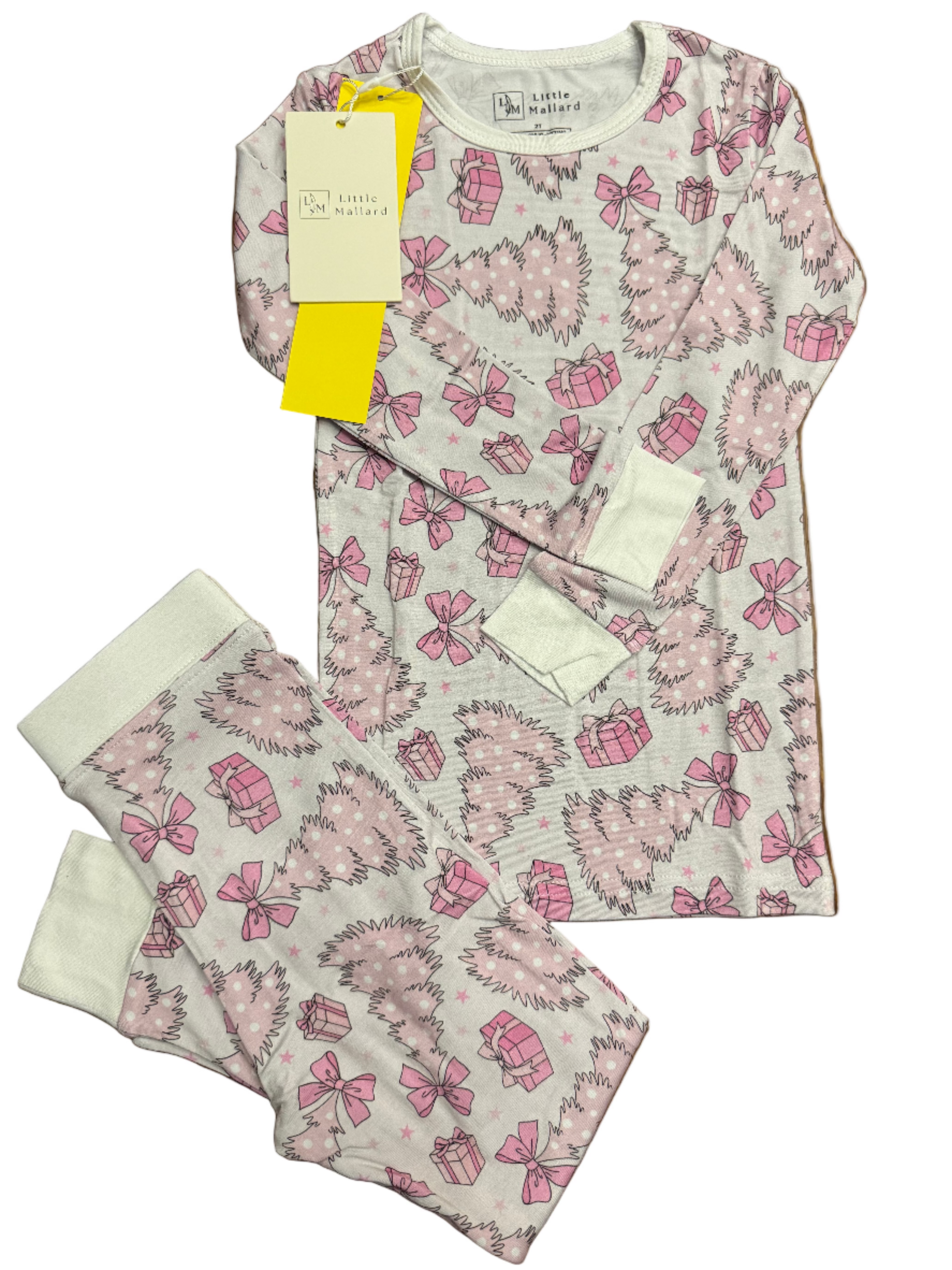 two piece toddler bamboo pajamas with pink christmas trees, bows, presents, stars on a pale pink background. 