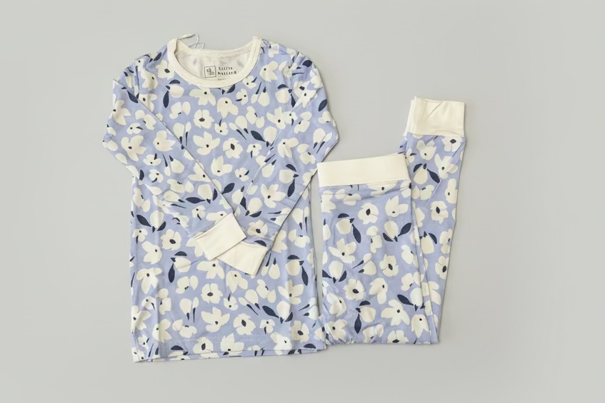 off purple two piece toldder pajama with white flowers and dark blue accents. Bamboo pajama is soft, breathable and perfect for keeping your little one cool