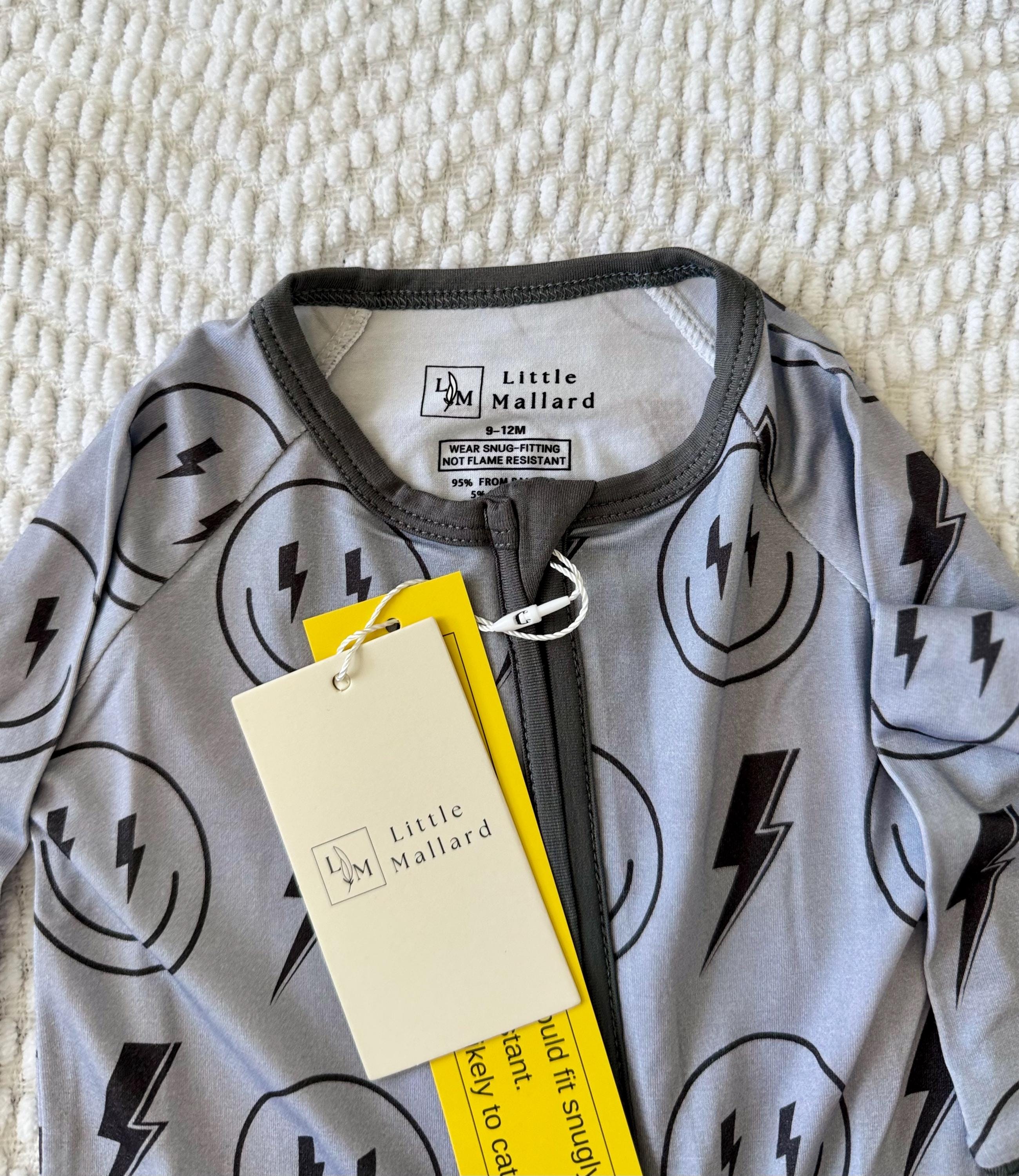 Little Mallard Bamboo stretchy Baby pajama with lightning bolt pattern with smiley faces. 