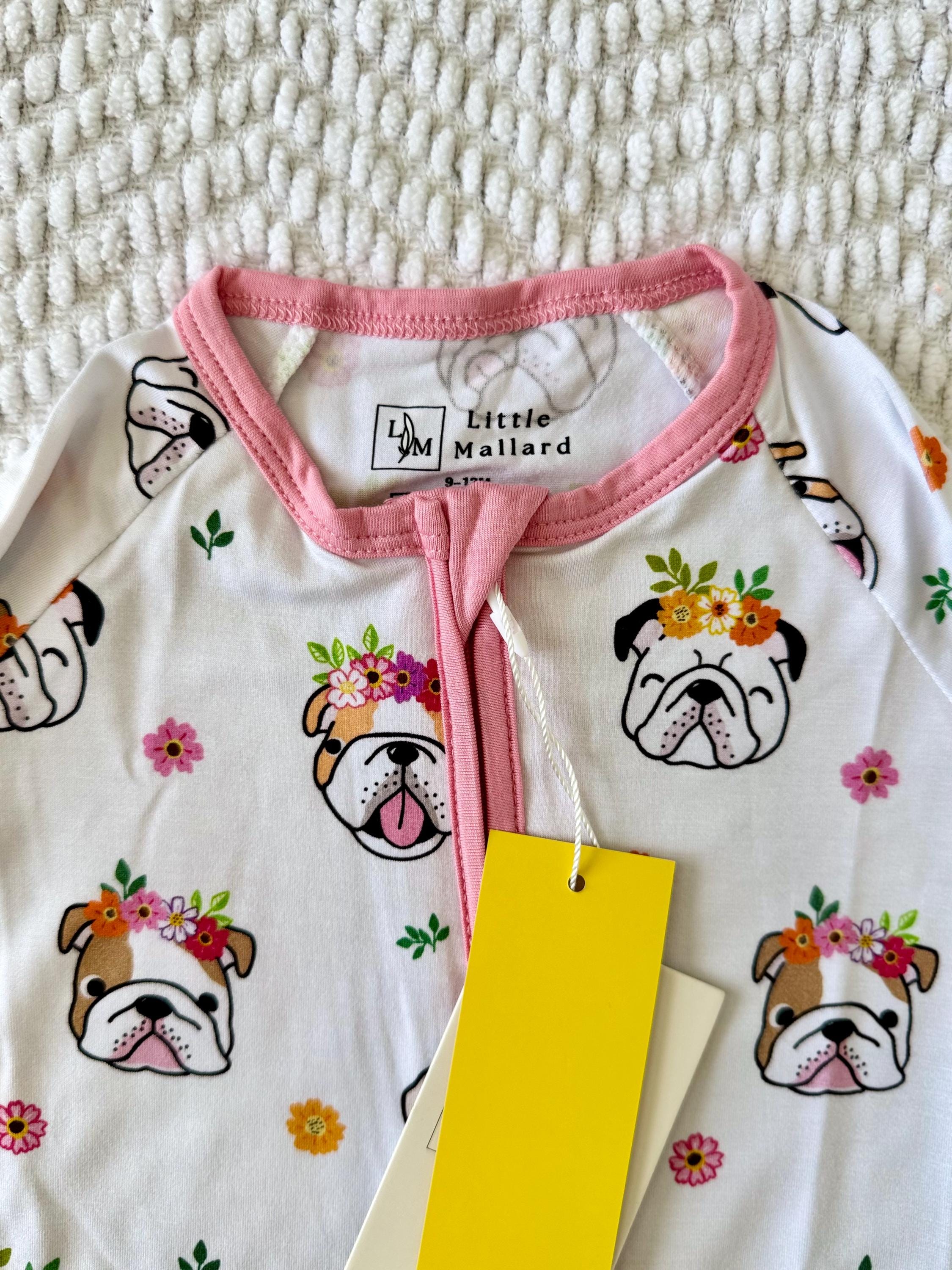 Super soft and breathable Baby convertible pajama with dog and floral illustrations and pink collar on a textured surface