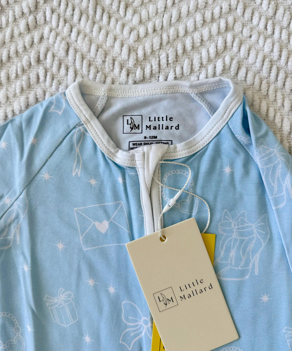 Light blue bamboo baby sleeper zipper with white girly accents. 