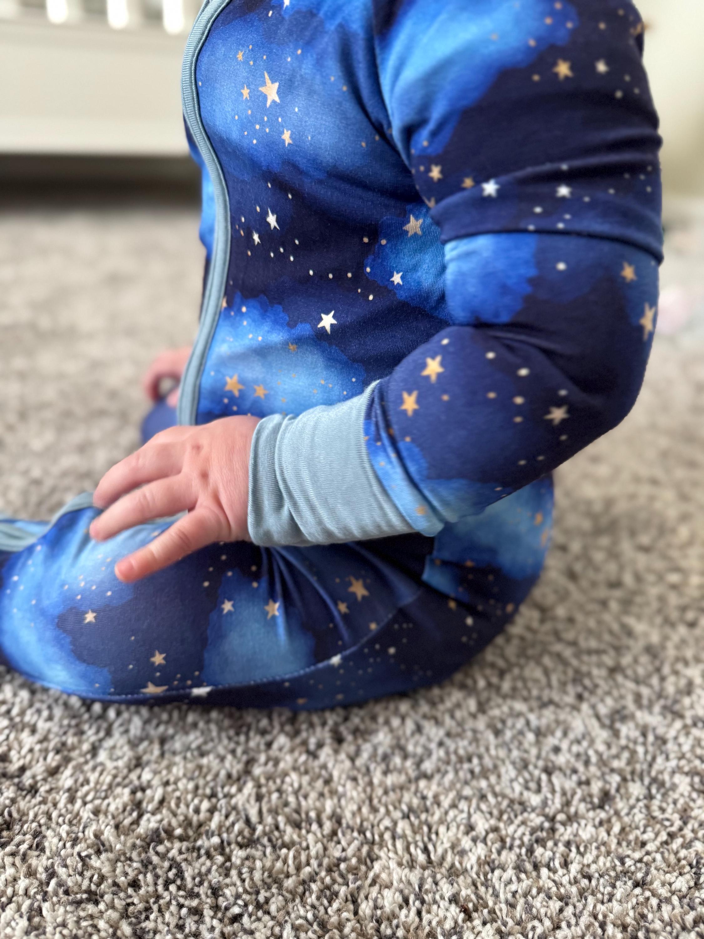 Soft baby convertible pajama/ onesie with galaxy pattern designed by Little Mallard. 