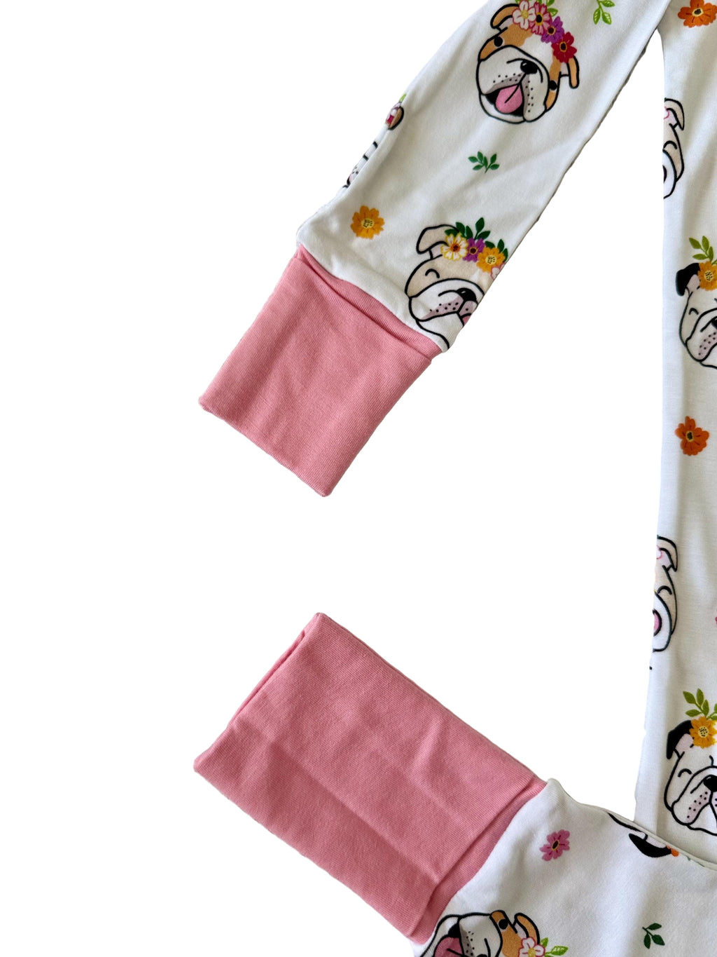 White baby sleeper with double zipper with dog print and flowers with pink accents. 